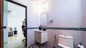 A modern bathroom with a toilet, sink, and mirror. There is a rug with a sea-themed design on the floor. - Cozy Luxury 2BR Pool Villa Retreat (PV1) (Hua Hin)
