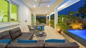 A covered outdoor area with a pool, seating, and plants. - Cozy Luxury 2BR Pool Villa Retreat (PV1) (Hua Hin)
