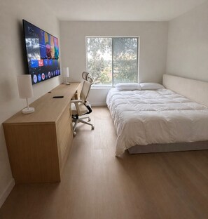A bedroom with a bed, a desk with a computer monitor, a chair, and a window. - Newly Renovated Cozy bed and private bath with AC in beautiful San Diego (San Diego)