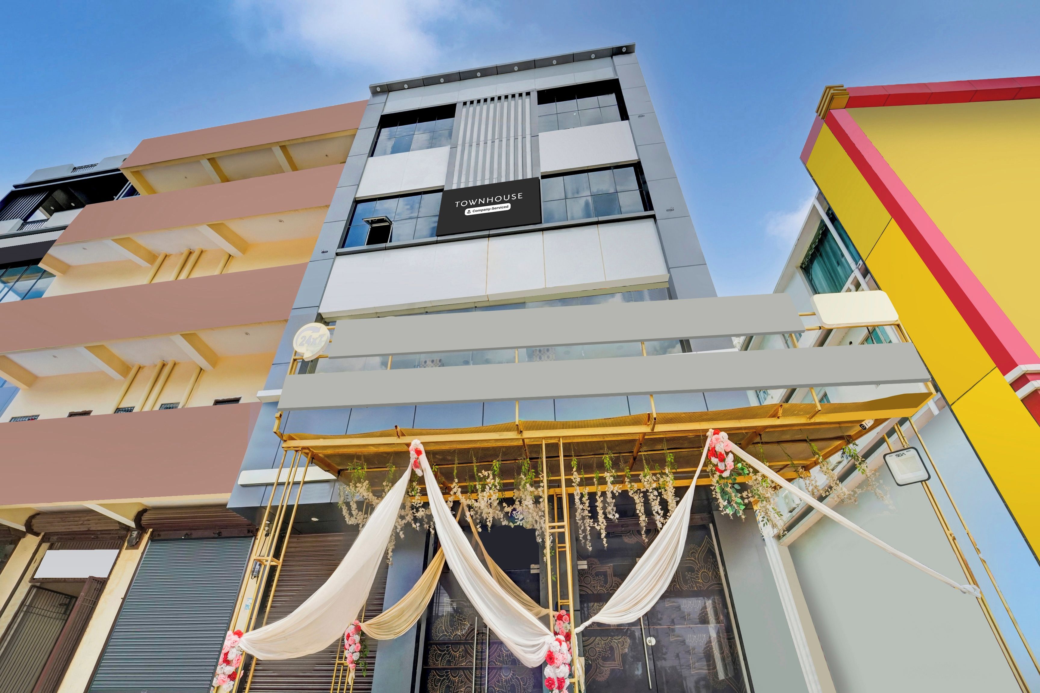 A multi-story building with a sign indicating it is a serviced apartment complex.