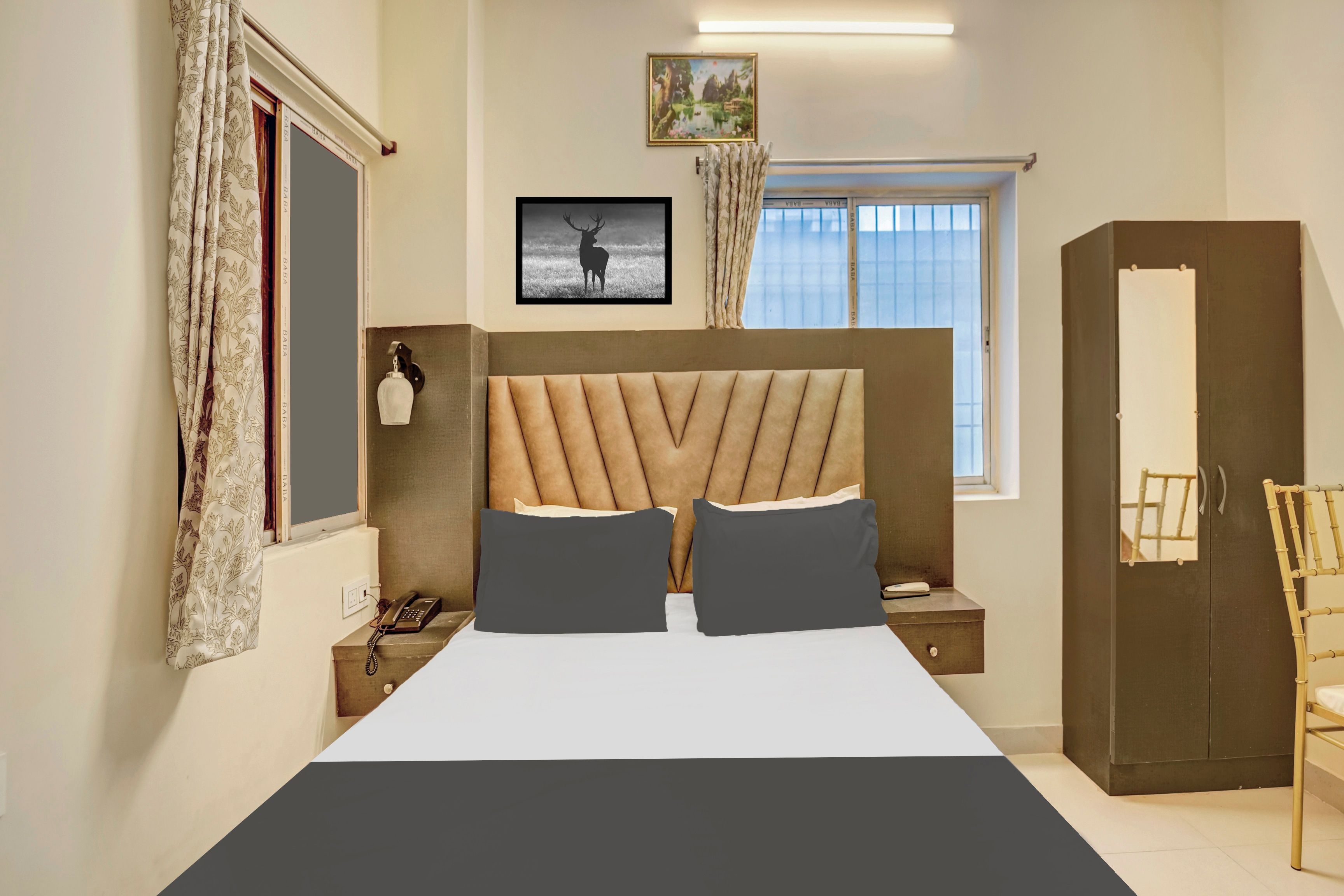 A bedroom with a bed, a bedside table with a lamp, a wardrobe, and a window with curtains.