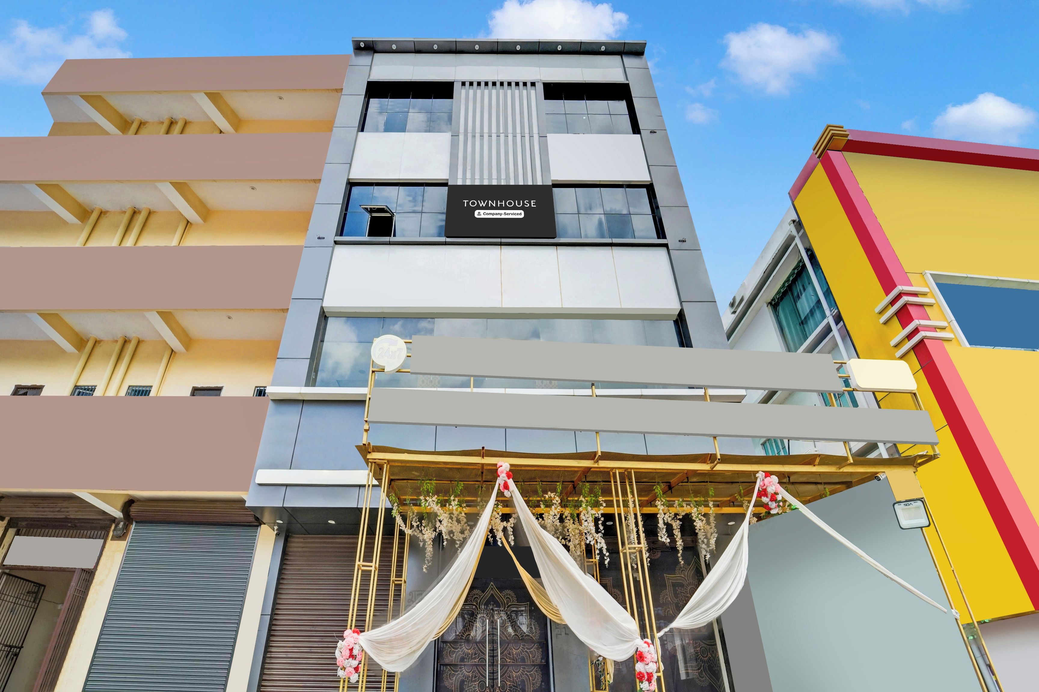 A multi-story building with a sign indicating 'TOWNHOUSE Company-Service.'