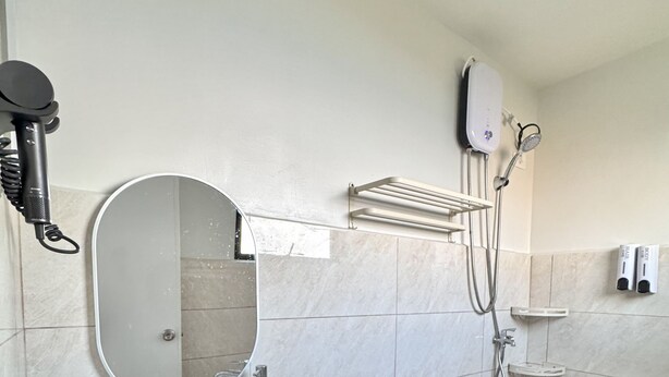 A bathroom with a sink, toilet, and shower. - Royal Oceancrest Panglao 1 (Dauis)