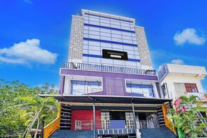 A multi-story building with a sign indicating it is a company-serviced townhouse.