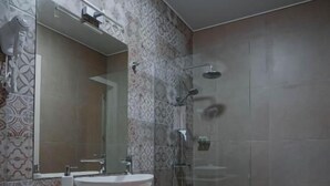 A modern bathroom with a glass shower enclosure, a vanity with a sink, and a mirror. - Mikheilis Marani Boutique Hotel  (Kvareli)