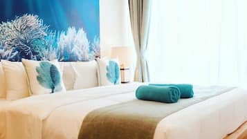 A hotel room with a bed, a large wall tapestry, and a window with curtains.