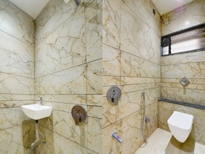 A bathroom with marble walls, a sink, a toilet, and a shower. - Collection O Aurangabad Shendra Midc (Chhatrapati Sambhajinagar)