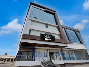 A modern building with a sign reading 'Collection' and a staircase leading to the entrance. - Collection O Aurangabad Shendra Midc (Chhatrapati Sambhajinagar)