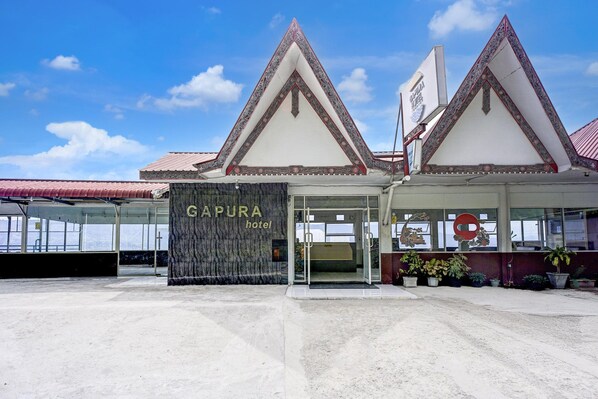 A hotel entrance with a sign reading 'CAPURA hotel' and a traditional architectural style with pointed roofs.