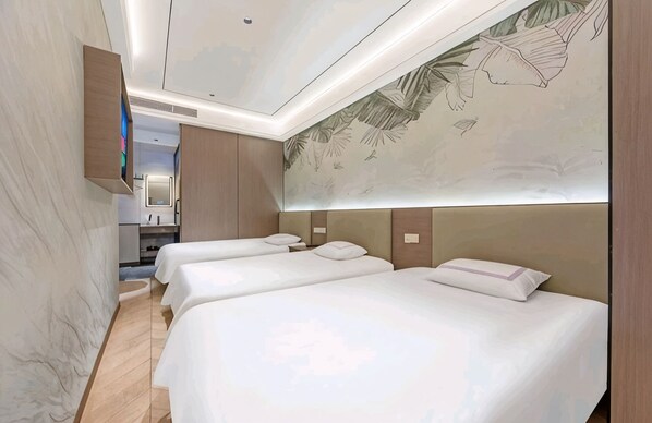 A hotel room with three beds, a minibar, and a mural on the ceiling.