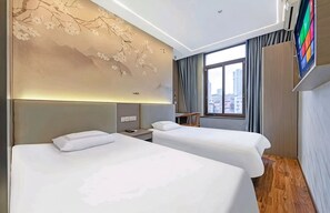 A hotel room with two beds, a large window, and a wall-mounted TV. - JINOUWANGUO HOTEL (Huangpu District)