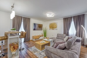 A modern living room with a sofa, coffee table, and dining area. - Wonderful pet-friendly 2-bedroom apartment with AC in quaint Pazin (Pazin)