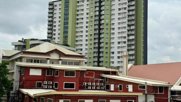 A multi-story building with a flat roof and a series of balconies. - We R Inn Hotel (Davao City)