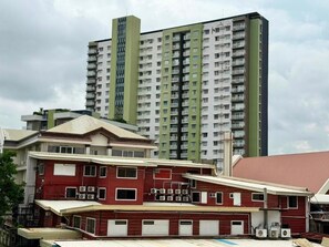 A multi-story building with a flat roof and a series of balconies.