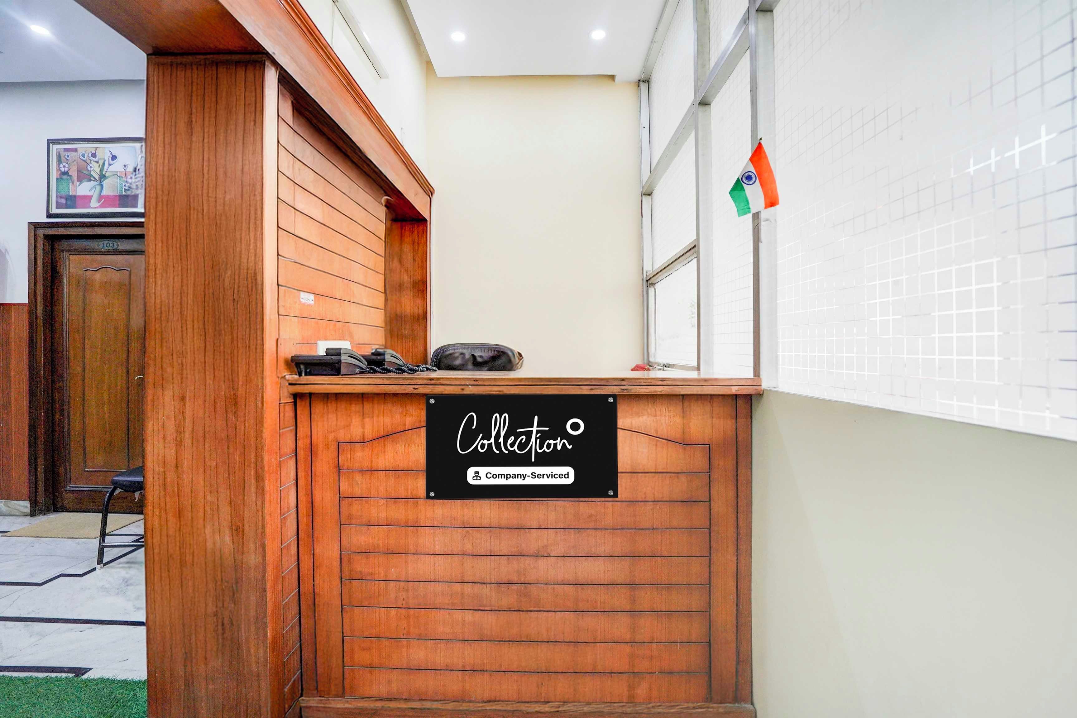 A reception desk with a sign indicating it is company-serviced.