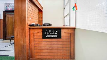 A reception desk with a sign indicating it is company-serviced.