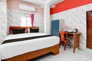 A hotel room with a bed, a desk, a chair, and a wardrobe. - Collection O Kolkata Jadavpur University (Kolkata)