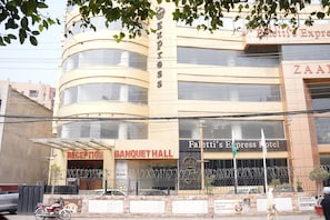 A hotel with a reception, banquet hall, and a sign for 'Paletti's Express Hotel'.