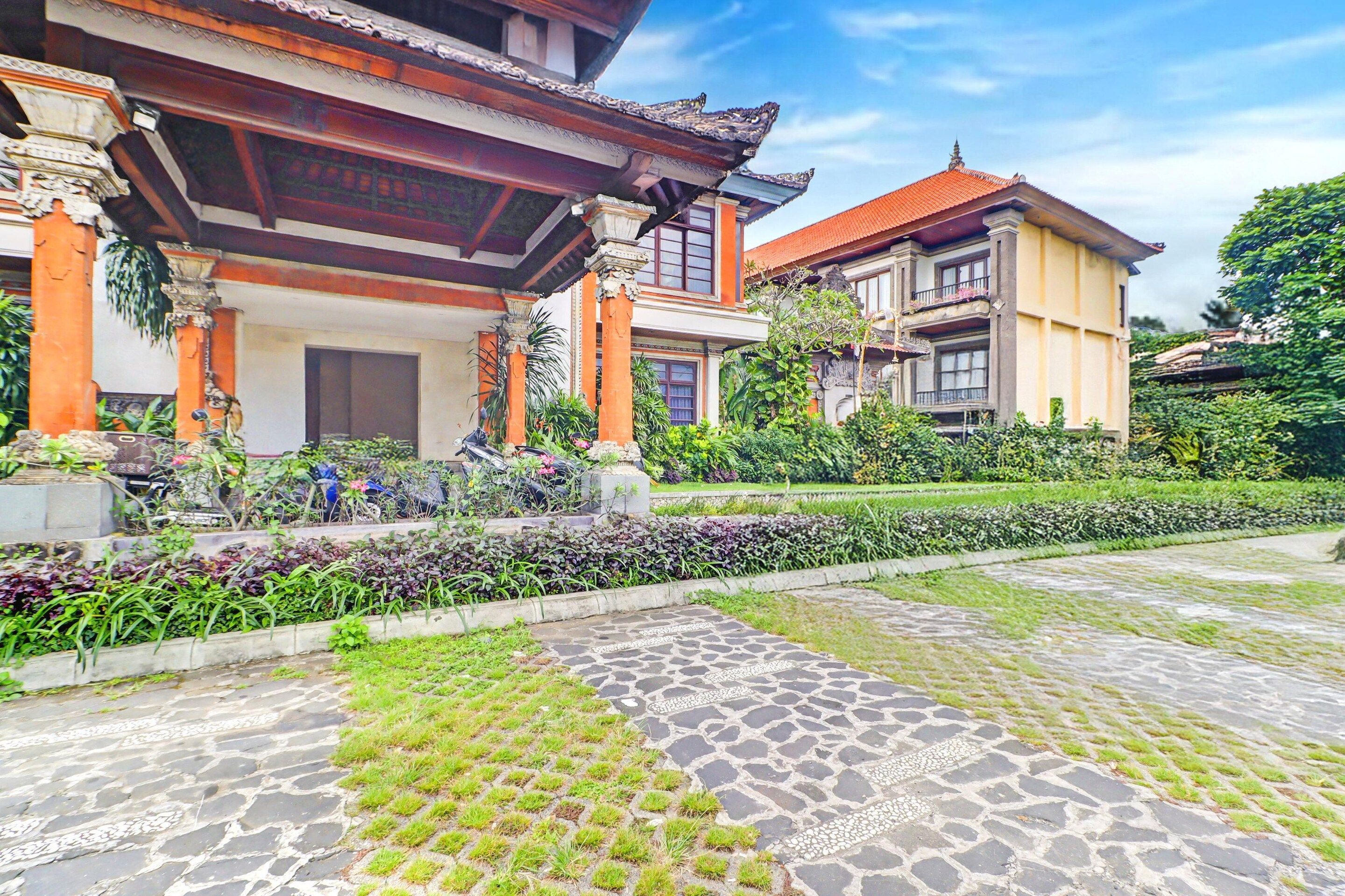 A traditional building with a tiled entrance and a garden area.