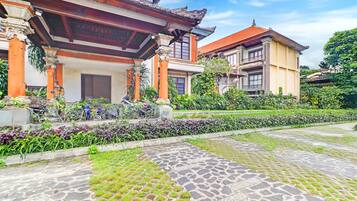 A traditional building with a tiled entrance and a garden area.