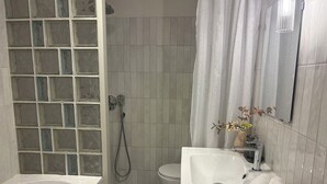 A bathroom with a bathtub, toilet, and sink. - Central Park View Apartment with a terrace and lake views features (Dobrich)