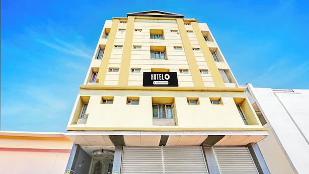 A hotel building with a sign reading 'HOTELO' and a company-serviced label. - OYO Kurnool Formerly Sai Priyanka Inn (Kurnool)
