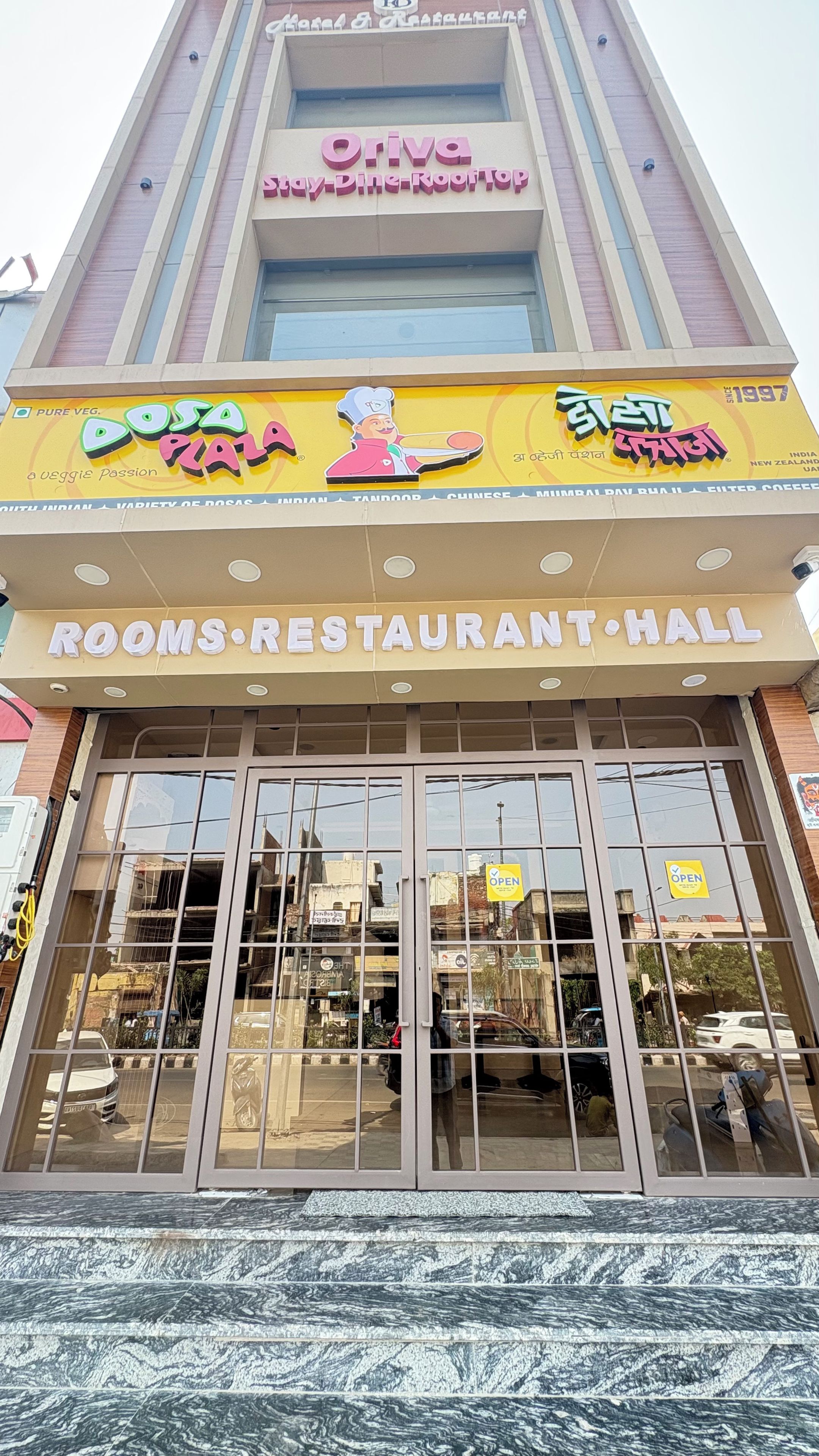 A building with a sign for 'Oriva' and 'Dosa Pala' restaurants.