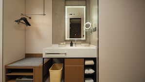 A modern bathroom with a vanity, mirror, and towel rack. - AtourHotelDalianXinghaiSquareRoosevelt (Dalian City)