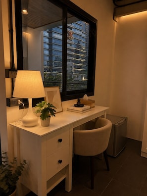 A modern, well-lit workspace with a desk, chair, lamp, and a view of a cityscape through a large window. - Time2Sleep (Bangkok)