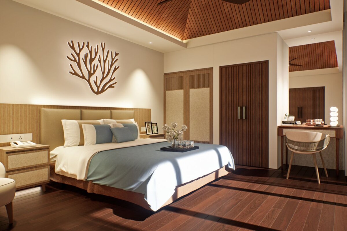 A modern bedroom with a large bed, bedside tables, a desk, and a chair.