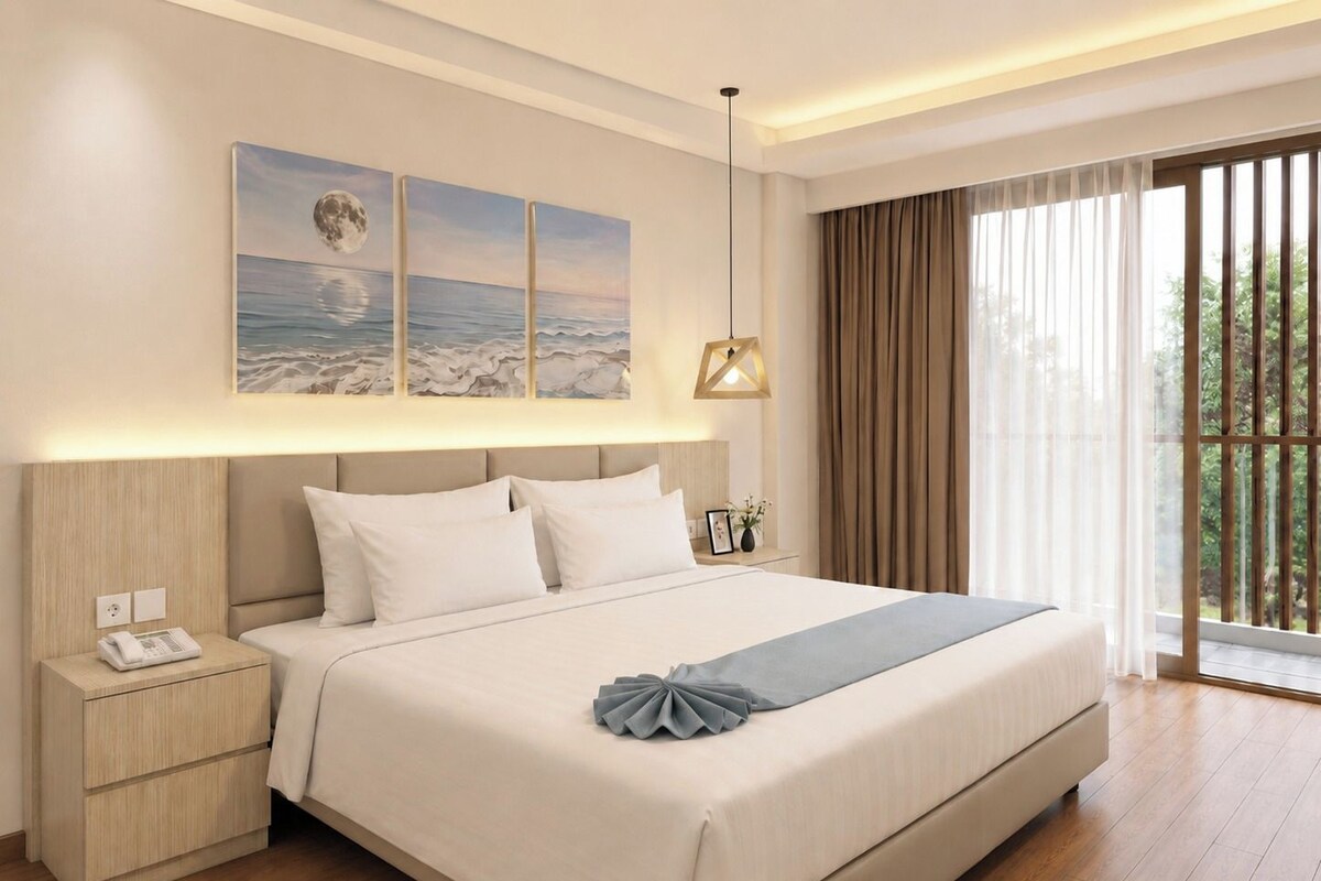 A hotel room with a large bed, bedside tables, a nightstand, a wall-mounted lamp, and a view of greenery through the window.