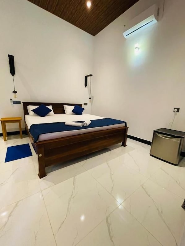 A bedroom with a wooden bed, white marble floor, and a ceiling fan.