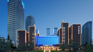 A hotel with a modern facade, multiple floors, and a prominent entrance. - Atour Hotel Dalian Xinghai Square (Dalian)