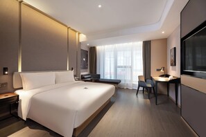 A modern hotel room with a large bed, a desk, and a TV. - Atour Hotel Dalian Xinghai Square (Dalian)