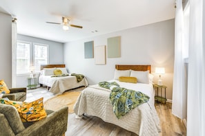 A bedroom with two beds, a ceiling fan, and artwork on the walls. - Game Day Hideaway! Spacious Opelika Escape (Opelika)