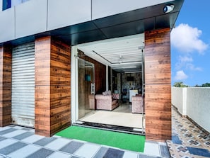 A modern building with a reception area, a glass door entrance, and a view of the interior.