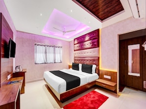 A modern bedroom with a bed, a desk, a window with curtains, and a door.