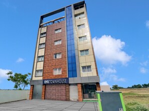 A multi-story building with a sign reading 'OYO TOWNHOUSE' at the ground level.