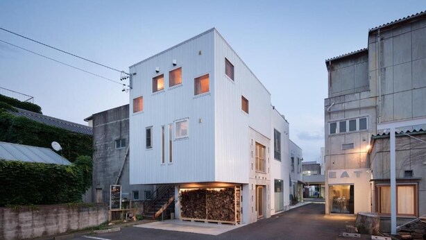 A modern building with a flat roof, a covered entrance, and a visible staircase leading to the entrance. - saino tsuno guesthouse (uedashi chuuou)