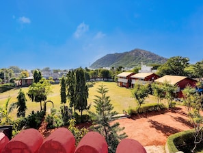A residential area with houses, a mountain, and a clear sky.