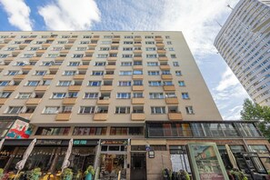 A multi-story building with a flat facade, numerous windows, and balconies. - Warsaw | Złota 11 | Comfortable Apartment | Downtown (Warszawa)