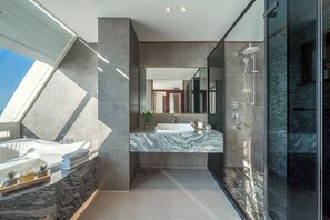 A modern bathroom with a skylight, a large mirror, a marble countertop, and a glass shower enclosure. - Coho penthouse Vung Tau Luxury 3BR Oceanfront, Private Pool & Sauna (Ho Chi Minh City)
