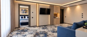 A hotel room with a bed, a TV, a coffee machine, and a sofa. - Hotel Eskada (Iași)