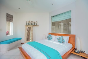 A bedroom with a bed, a bench, a window, and a wall-mounted shelf with decorative items. - K Villa Seminyak by Premier Hospitality  (Seminyak)