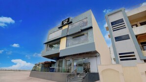 A modern hotel with a two-story structure, a visible staircase, and a clear sky. - OYO hotel O Beemli Beach Visakhapatnam (Visakhapatnam)
