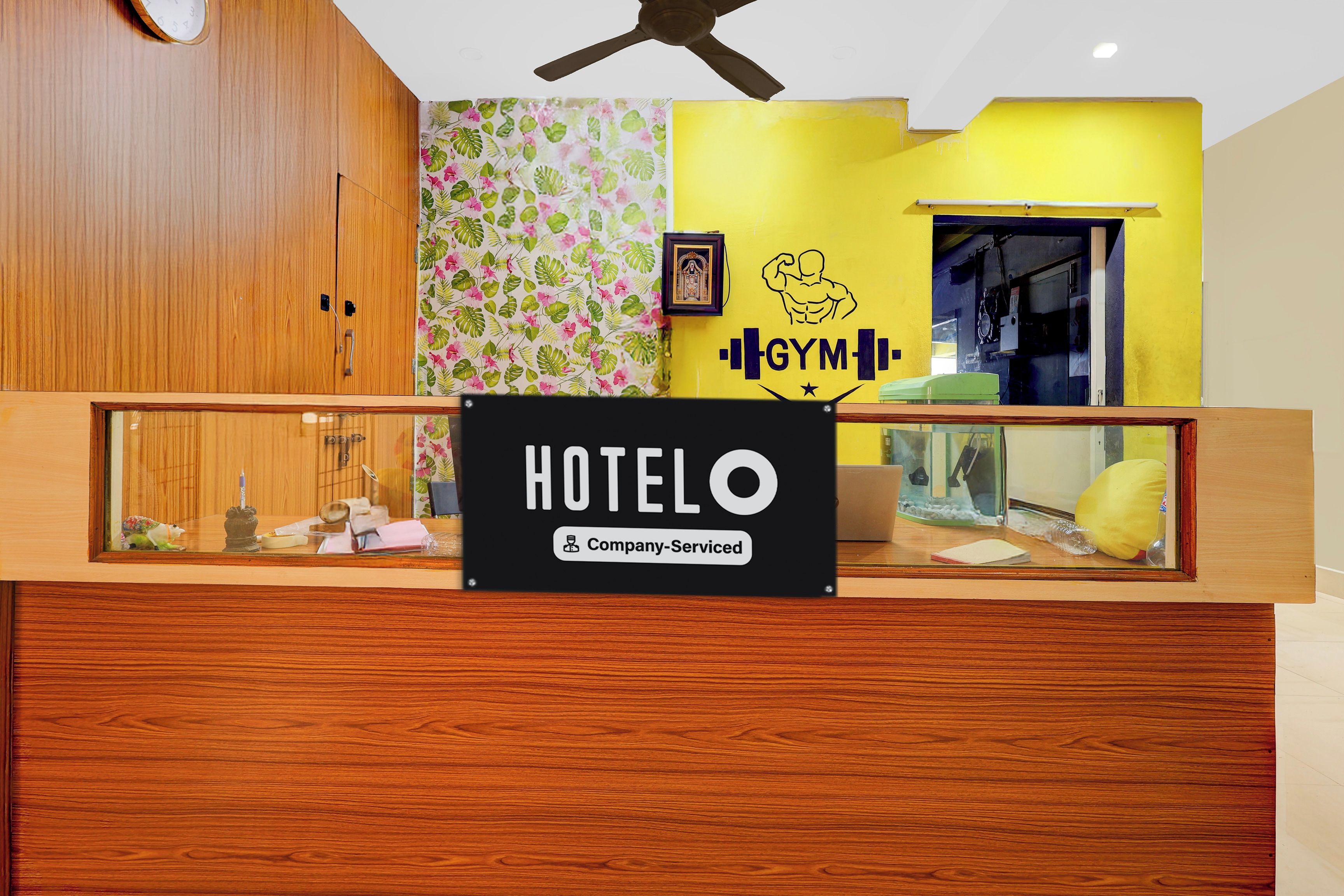 A reception desk with a sign that reads 'HOTEL' and 'Company Serviced.'