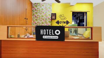A reception desk with a sign that reads 'HOTEL' and 'Company Serviced.'