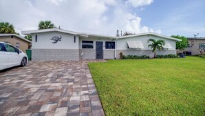 A modern two-story house with a paved driveway and a well-maintained lawn. - 1/2 Mi to Ocean! Couple's Haven in Satellite Beach (Satellite Beach)