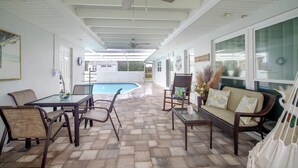 A covered outdoor area with a pool, wicker furniture, and a ceiling fan. - 1/2 Mi to Ocean! Couple's Haven in Satellite Beach (Satellite Beach)
