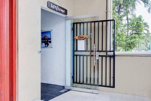 A gated entrance with a 'Welcome' sign and a 'Come in we're open' sign. - Spacious Triple Suite for Groups With Free Wifi (Yogyakarta)